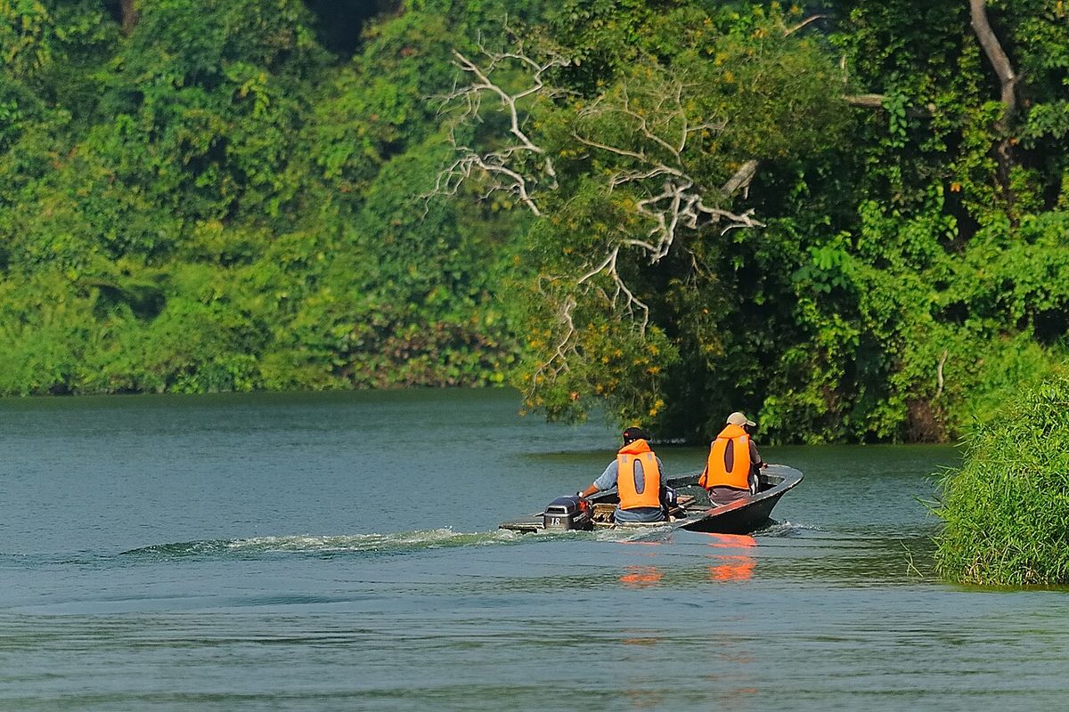 Men wearing orange lifejackets in a speedboat